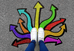 Person standing in the middle of arrows pointing in all directions.