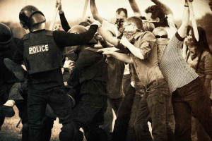 Riot police fighting with a group of masked protestors