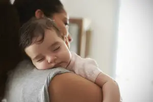 Baby sleeping on mom's shoulder