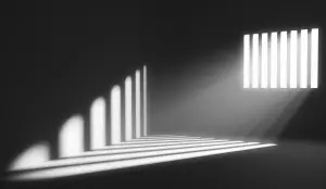 Light shining from window into dark prison cell