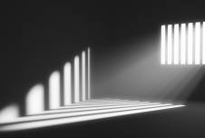 Light shining from window into dark prison cell