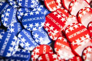 Collection of blue pins that say Democrat and red pins that say Republican