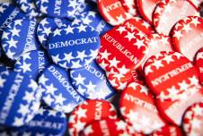 Collection of blue pins that say Democrat and red pins that say Republican