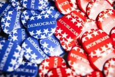 Collection of blue pins that say Democrat and red pins that say Republican
