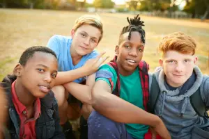 Four boys in a field posing for the camera