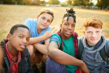 Four boys in a field posing for the camera