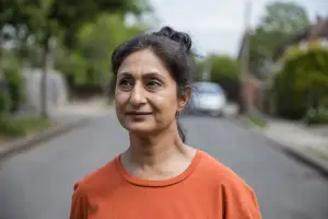 Woman standing in the street looking pensive