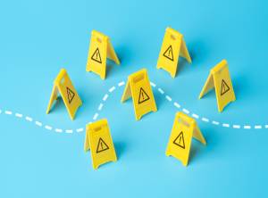 A dotted line path through seven yellow caution signs