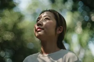 Woman in nature looking up