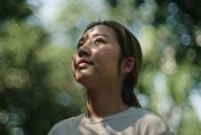 Woman in nature looking up