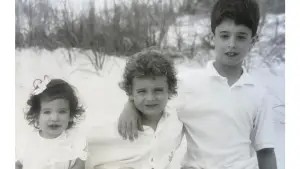 A young girl with her two older brothers