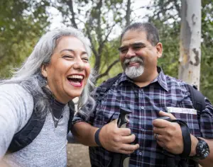 Couple in the woods smiling and laughing