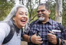 Couple in the woods smiling and laughing