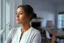 Pensive woman looking out a window