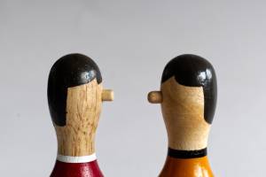 Two wooden puppets facing each other as if having a conversation