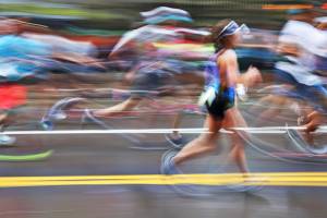 Blurry marathon runners with one runner more in focus
