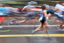 Blurry marathon runners with one runner more in focus