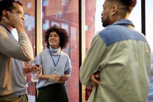 Three coworkers standing around and talking