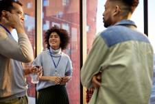 Three coworkers standing around and talking