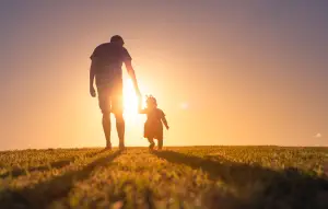 A father walking with his daughter.