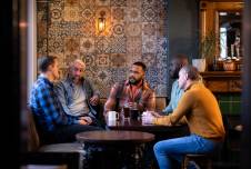 A diverse group of men talking.