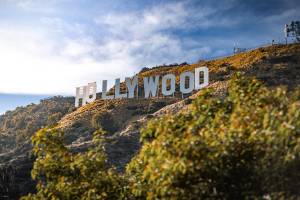 The Hollywood sign on a hill, with clouds above