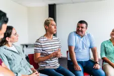 People seated in a circle for group therapy