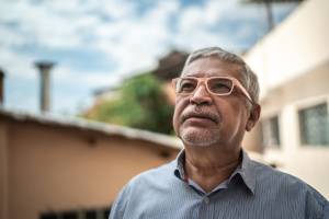 Man looking up at the sky outside a house