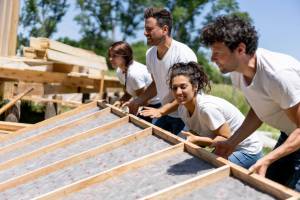 Volunteers working on building a house
