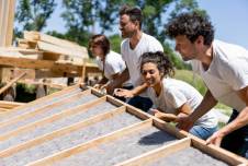 Volunteers working on building a house