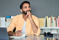 Man with chin on fist looking into distance