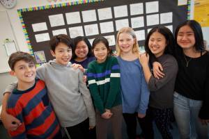 Group of middle school students smiling for the camera