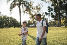 Father and son walking in the park talking
