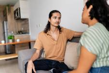 Couple sitting on the couch having a serious conversation