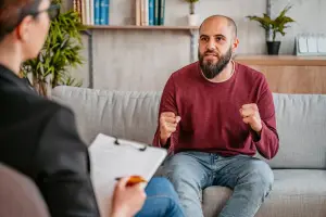 Therapist talking to client sitting on a couch
