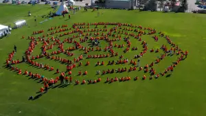 Aerial view of the Human Spiderweb with people in a spiderweb shape on a soccer field