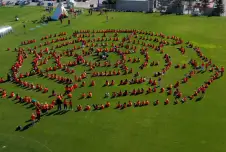 Aerial view of the Human Spiderweb with people in a spiderweb shape on a soccer field