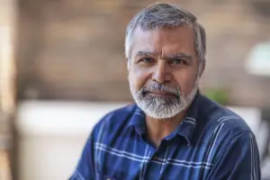 Serious man with gray hair in a dress shirt