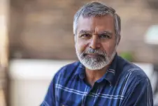 Serious man with gray hair in a dress shirt