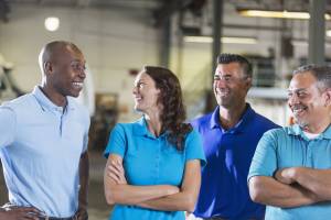 Four coworkers smiling at each other