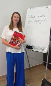 An image of Liudmyla Herasymenko next to a white board.