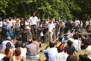 Man speaking to a crowd at Speaker's Corner in Hyde Park, London.