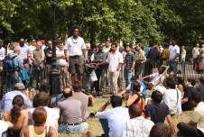 Man speaking to a crowd at Speaker's Corner in Hyde Park, London.