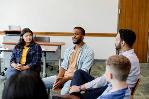 Students sitting in a circle having a discussion in the classroom