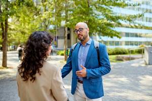 Two people having a discussion outdoors