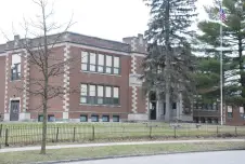 An elementary school with trees in front of it