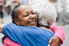 Two women hugging and smiling