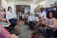 Group of teaching talking and smiling in the break room