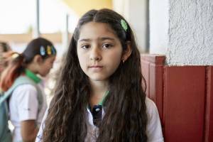 Quiet child in early childhood classroom observing surroundings