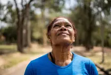 Woman outdoors looking up at the sky